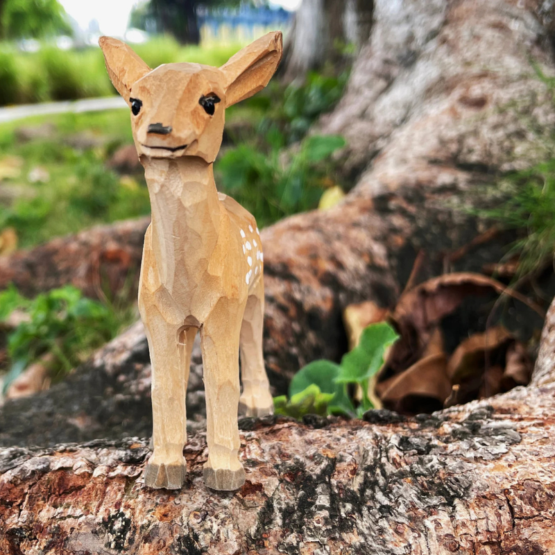 Hand-carved deer ornament by Sydney's Collection, showcasing unique wood textures, perfect for animal lovers.