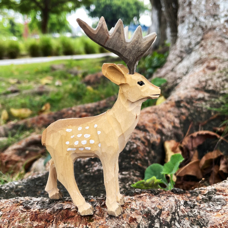 Hand-carved wooden deer ornament with detailed craftsmanship, perfect gift for deer lovers and nature enthusiasts.