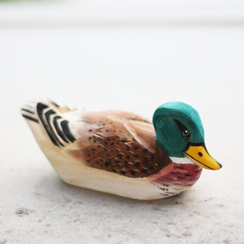 Hand-carved wooden duck ornament showcasing unique textures and vibrant colors, perfect for bird enthusiasts.