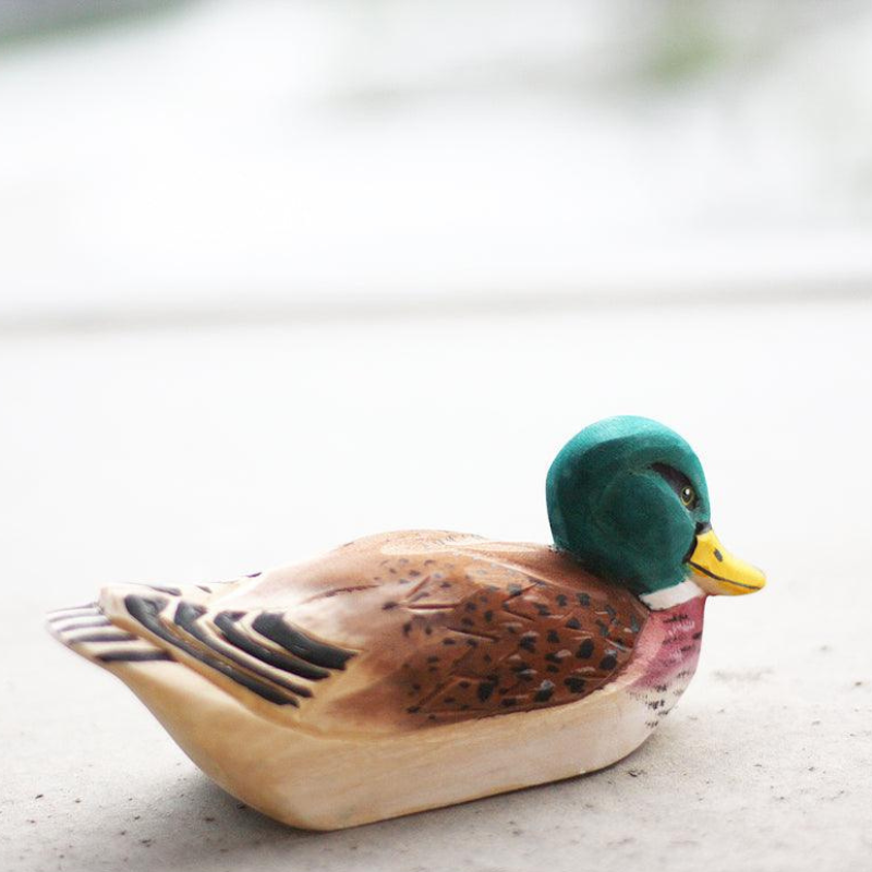 Hand-carved duck ornament showcasing natural wood textures, perfect gift for duck lovers and bird enthusiasts.