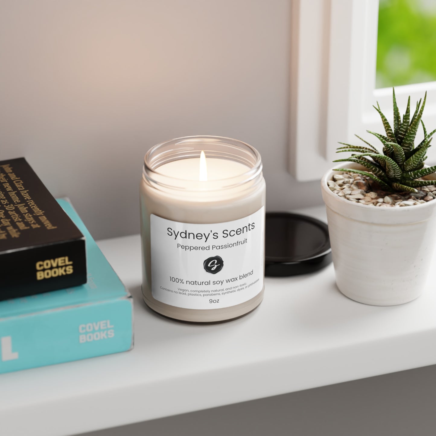 A luxurious glass jar soy candle is showcased, the wick is lit, and the scent is peppered passionfruit.