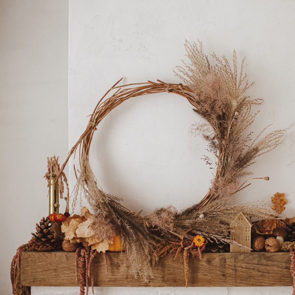 A decorated fireplace mantel slipcover. Decorated with wreaths, and foliage.