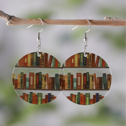 Clear acrylic circle shaped mini bookshelf earrings with colourful books inside.