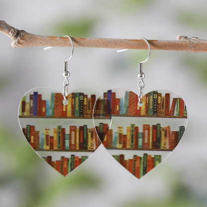 Clear acrylic heart shaped mini bookshelf earrings with colourful books inside.