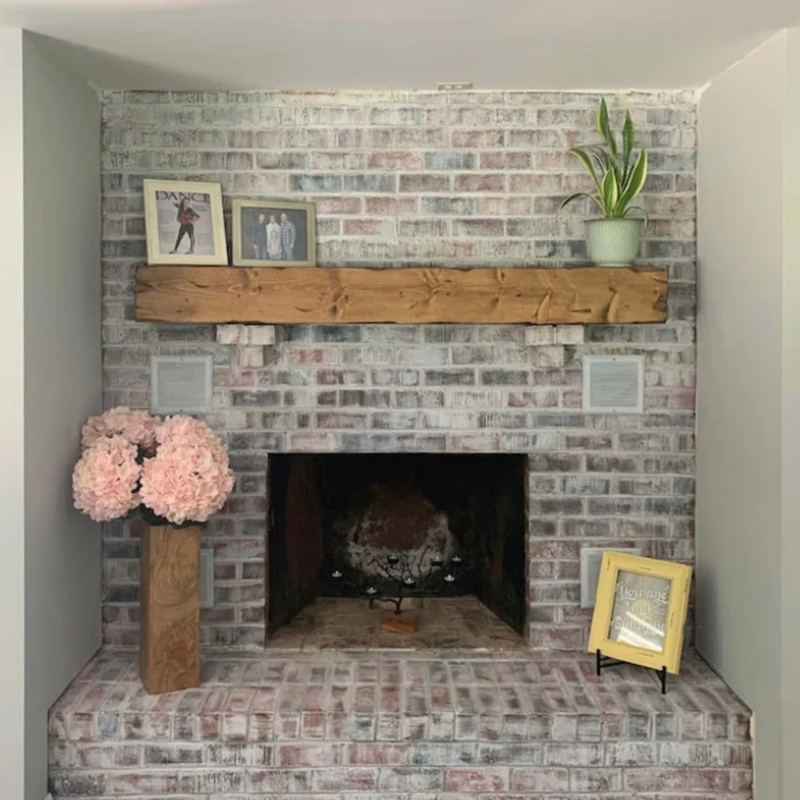 A rustic, hand-distressed, Canadian Made Red Oak fireplace mantel slipcover sits over an existing floating mantel shelf for an instant fireplace update. Stained and finished with protective polyurethane gloss.