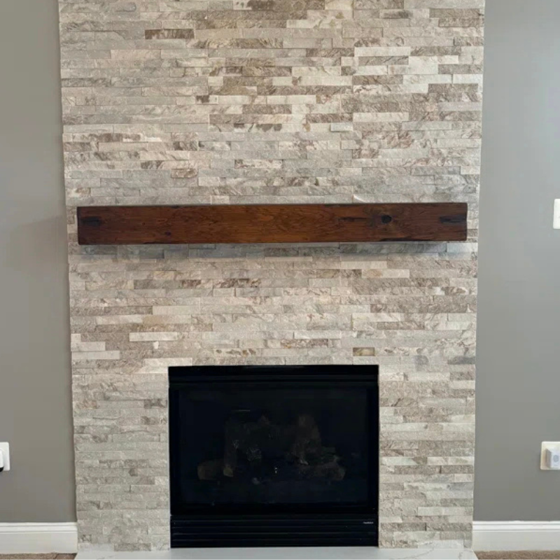 A rustic, hand-distressed, Canadian Made Red Oak fireplace mantel slipcover sits over an existing floating mantel shelf for an instant fireplace update. Stained and finished with protective polyurethane gloss.