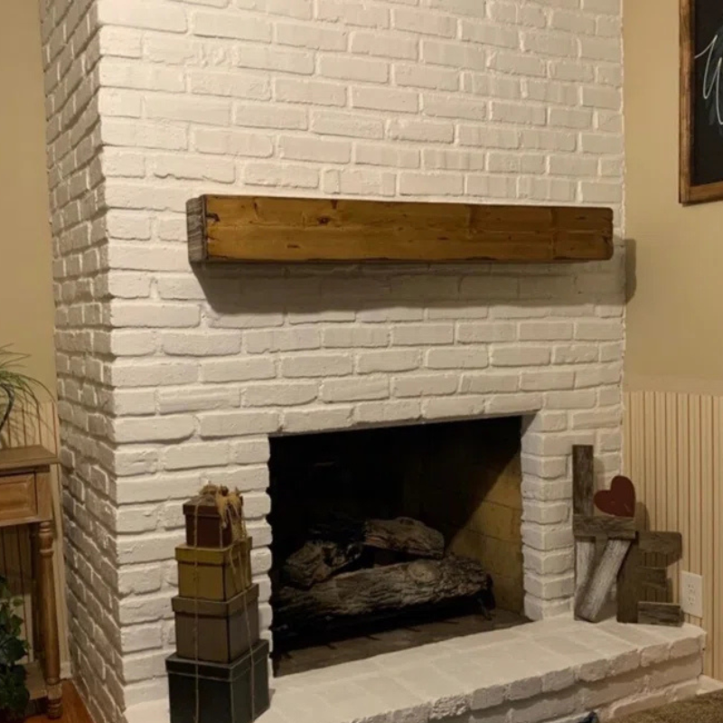 A rustic, hand-distressed, Canadian Made Red Oak fireplace mantel slipcover sits over an existing floating mantel shelf for an instant fireplace update. Stained and finished with protective polyurethane gloss.