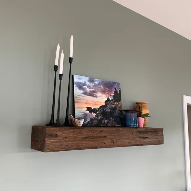 A rustic, hand-distressed, Canadian Made Red Oak fireplace mantel slipcover sits over an existing floating mantel shelf for an instant fireplace update. Stained and finished with protective polyurethane gloss.