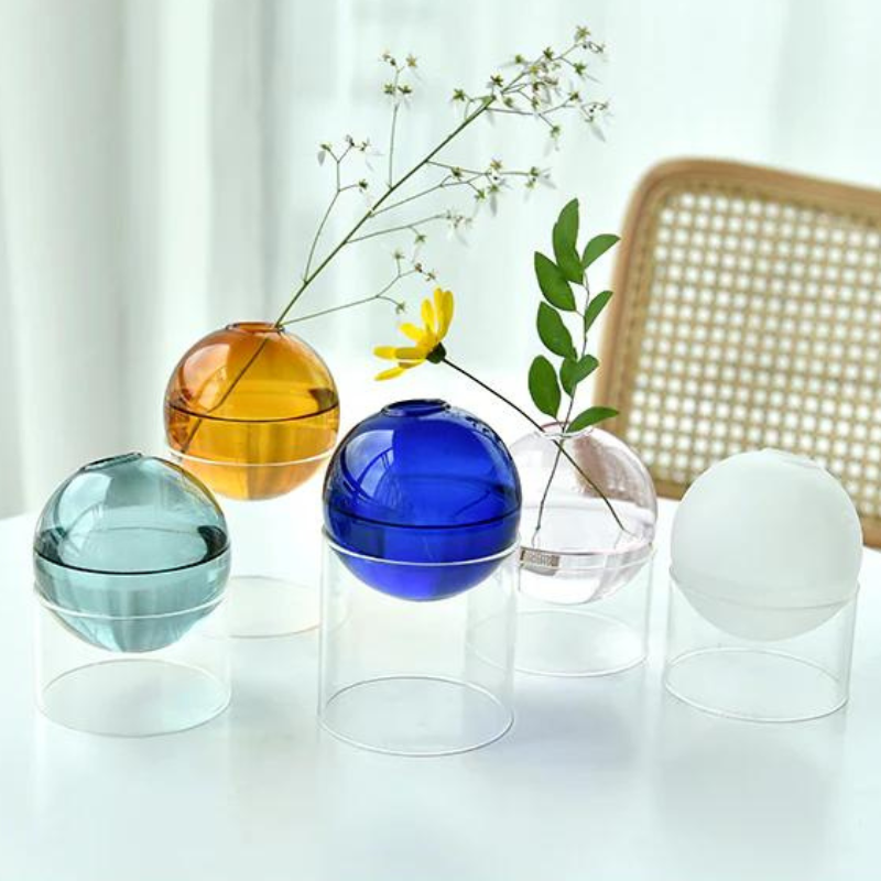 Circular Glass sphere vases created with colorful blown glass in an orb shape.