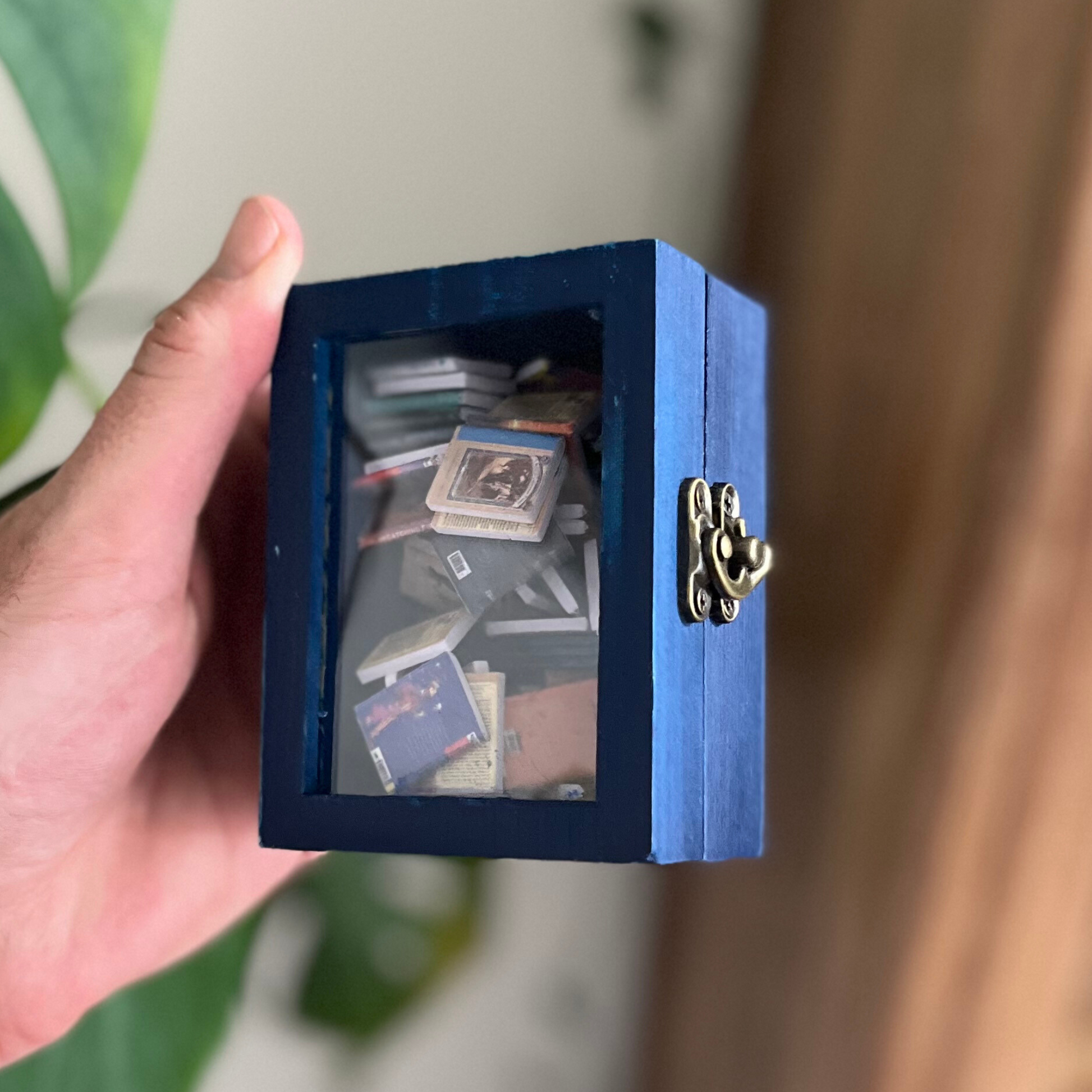 Mini Blue Anxiety Bookshelf,  a miniature library shaker fidget toy.