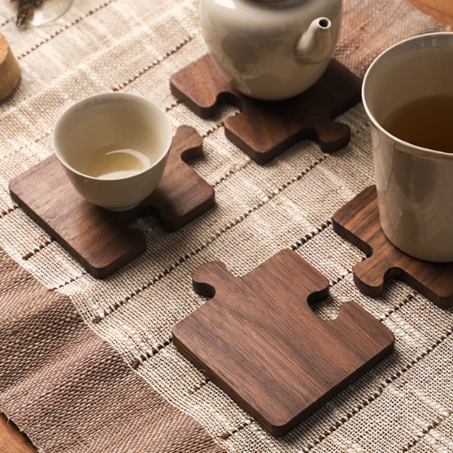 A dark stained wood puzzle piece coaster set of four.