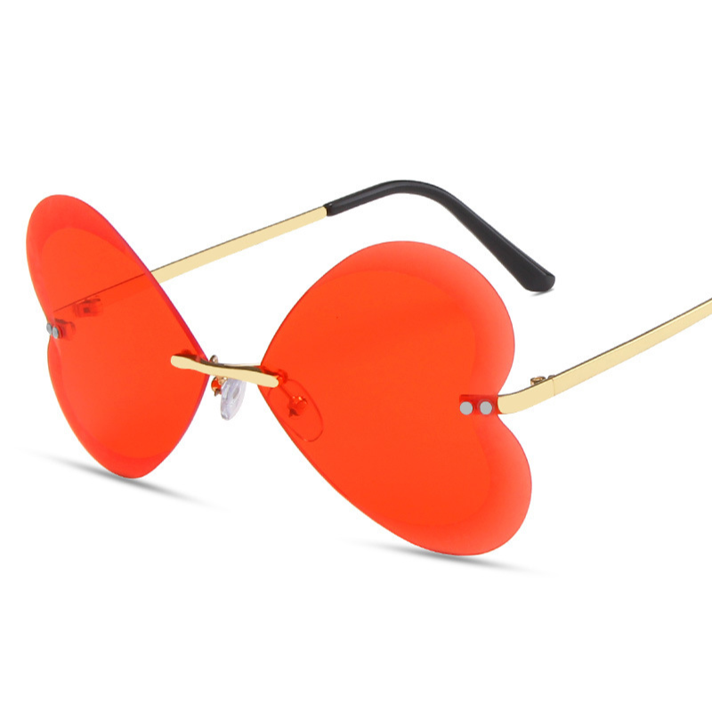 Heart sunglasses, frameless in red color are displayed from a diagonal angle.