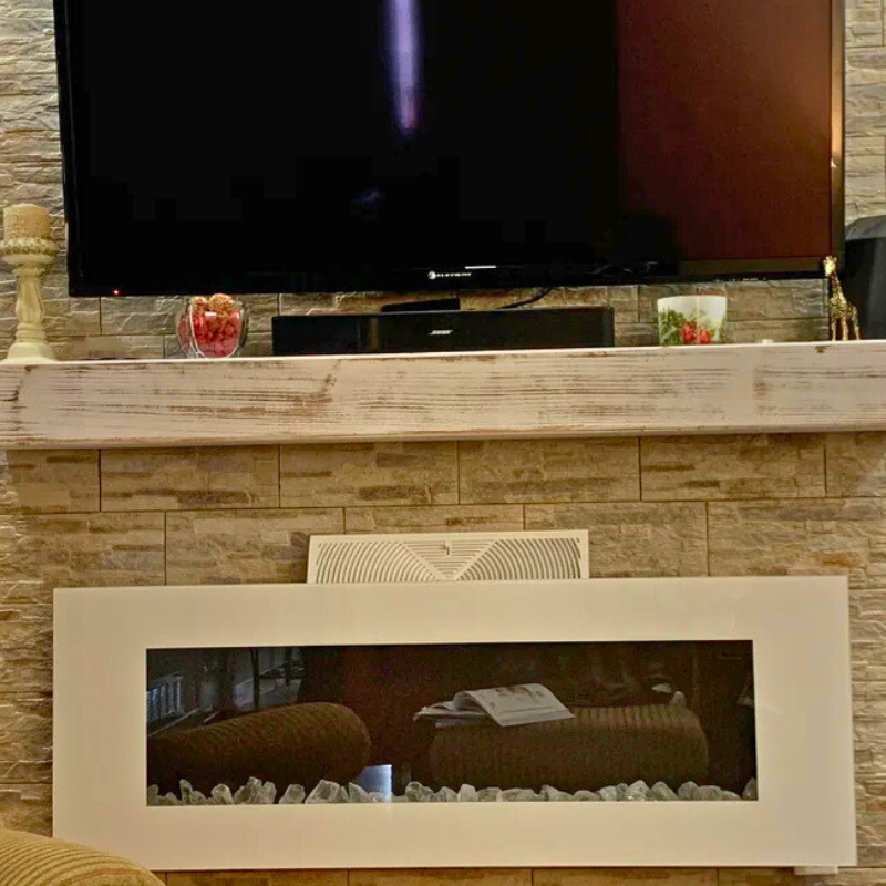 A white mantel slipcover is displayed. This floating shelf fireplace mantel is whitewashed for a rustic and distressed look. Handmade from natural Alderwood.