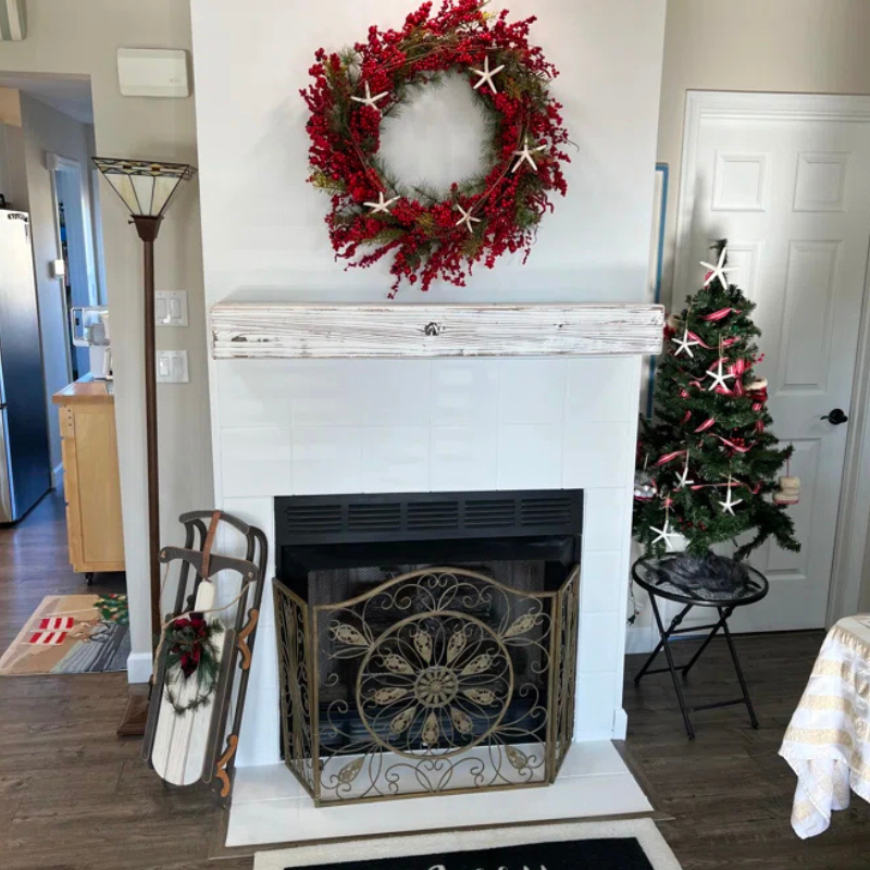 A white mantel slipcover is displayed. This floating shelf fireplace mantel is whitewashed for a rustic and distressed look. Handmade from natural Alderwood.