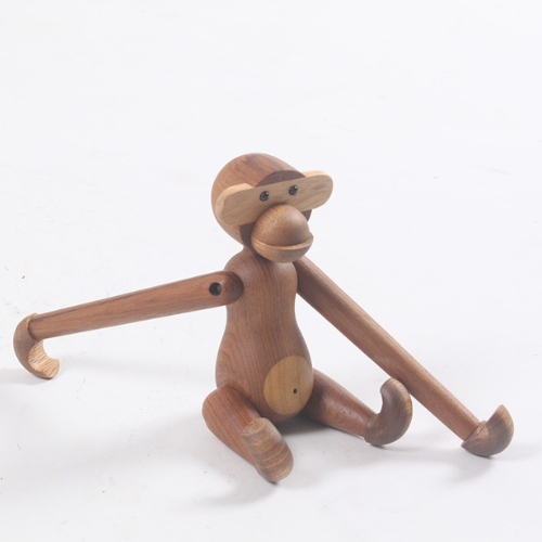 Handmade poseable wood monkey figurine made from teak and limba.