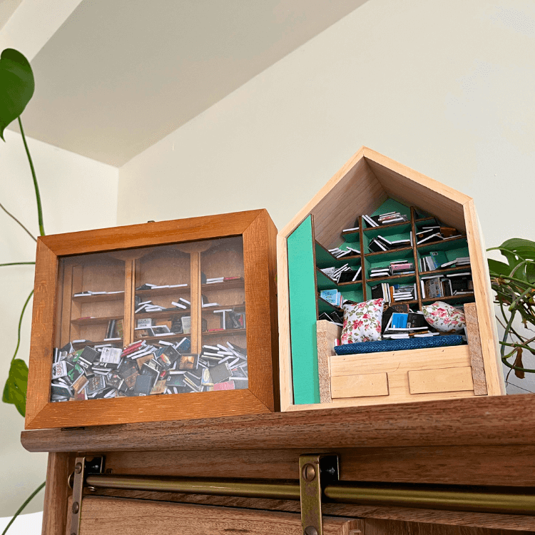 Anxiety Bookshelf and Anxiety Book Room  sit atop a real bookcase as shelf decor.