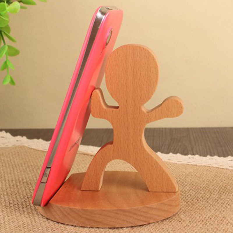 Wooden animal-shaped phone stand in tai chi pose holding smartphone upright.