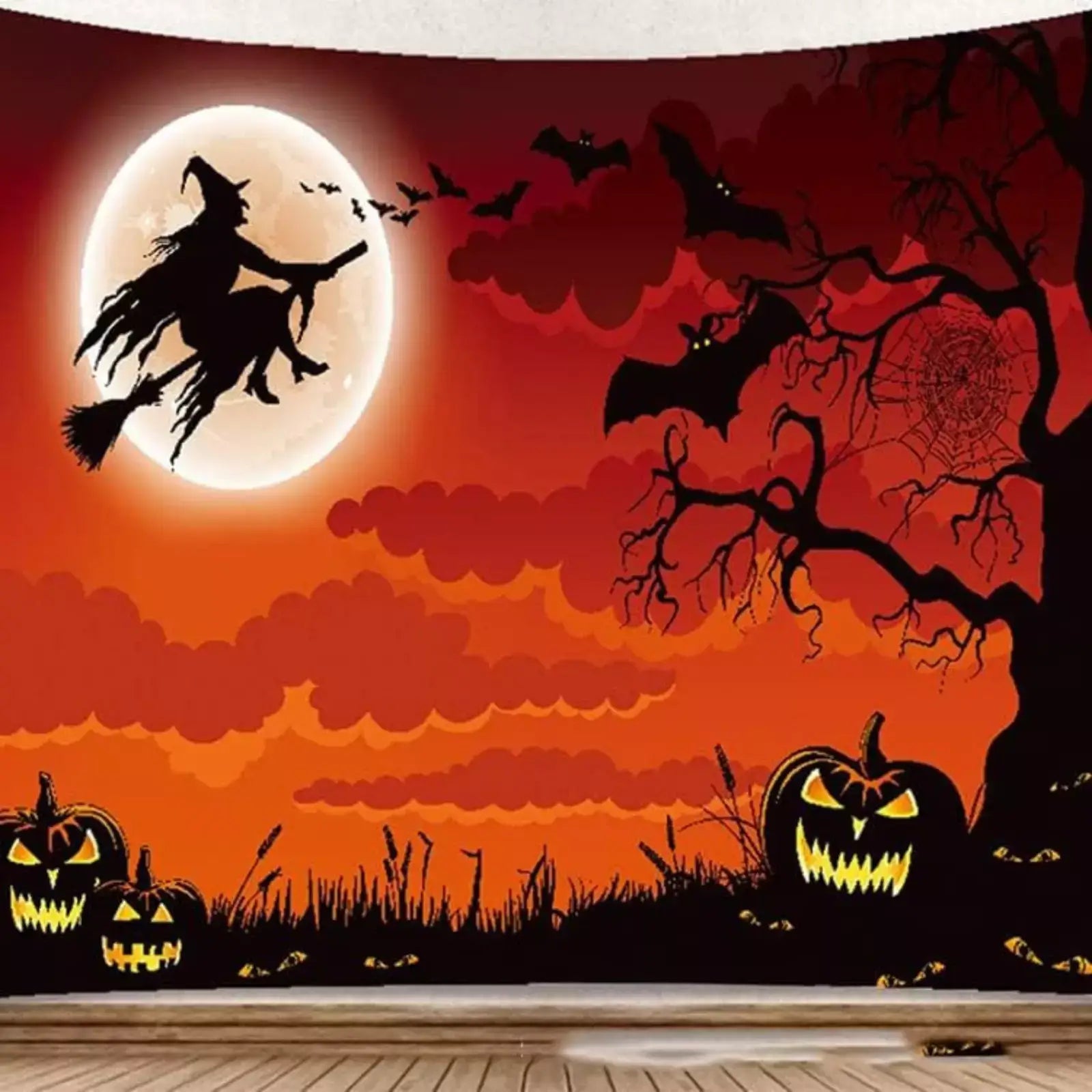 Halloween Witch Silhouette Tapestry with pumpkins, bats, and a full moon in a spooky orange sky.