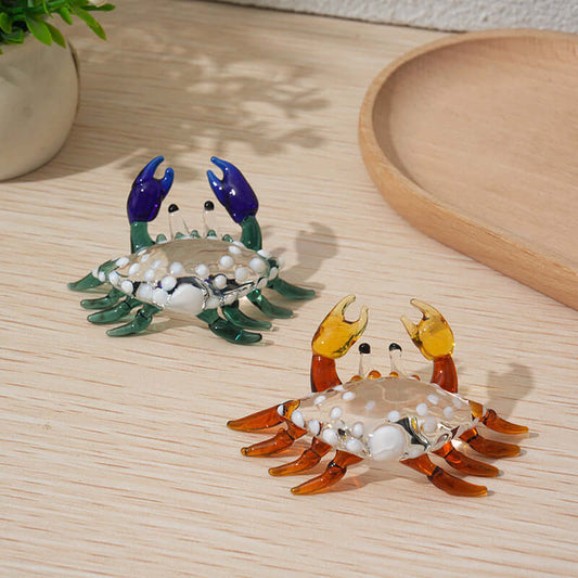 Hand-blown glass crab paperweights in vibrant colors, perfect for decor or as functional desk accessories.