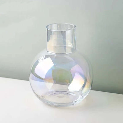 Iridescent glass sphere vase showcasing soft color shifts in sunlight against a minimalist backdrop.