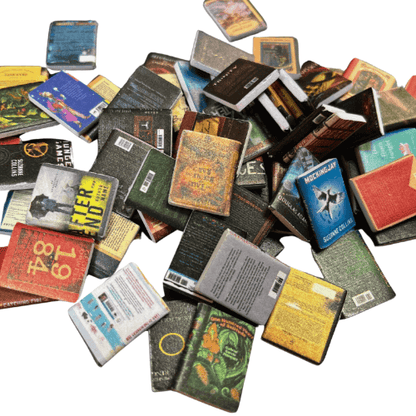 A collection of miniature books from the Four Piece Anxiety Bookshelf Collection Bundle scattered on a surface.