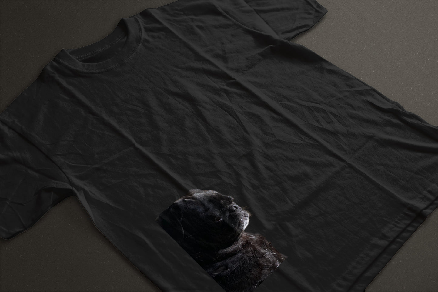 a black pug side profile picture on the bottom left of a tshirt