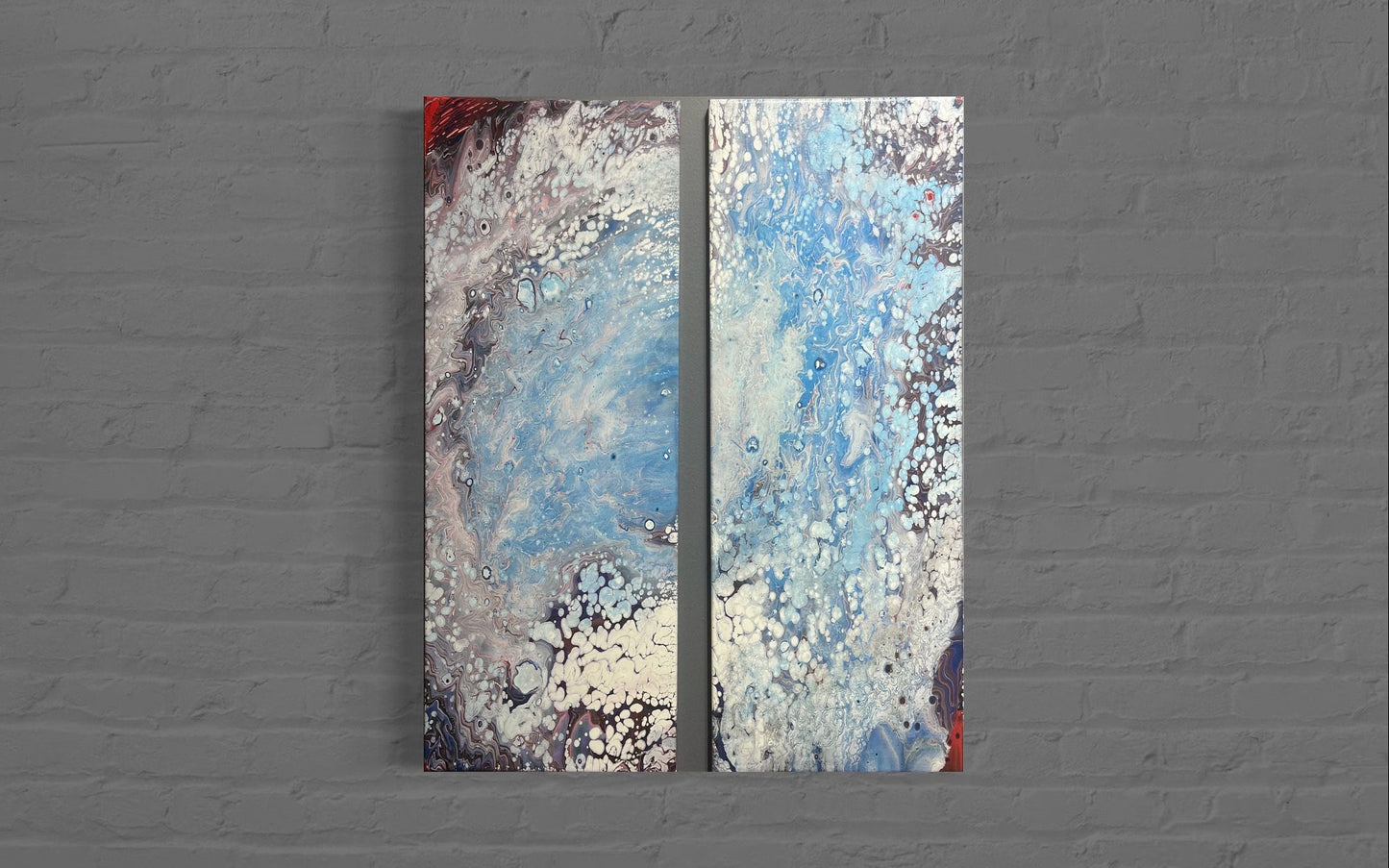 fluid art pour painting diptych that resembles a hurricane 