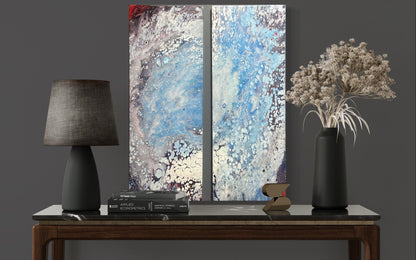 fluid art pour painting diptych that resembles a hurricane 