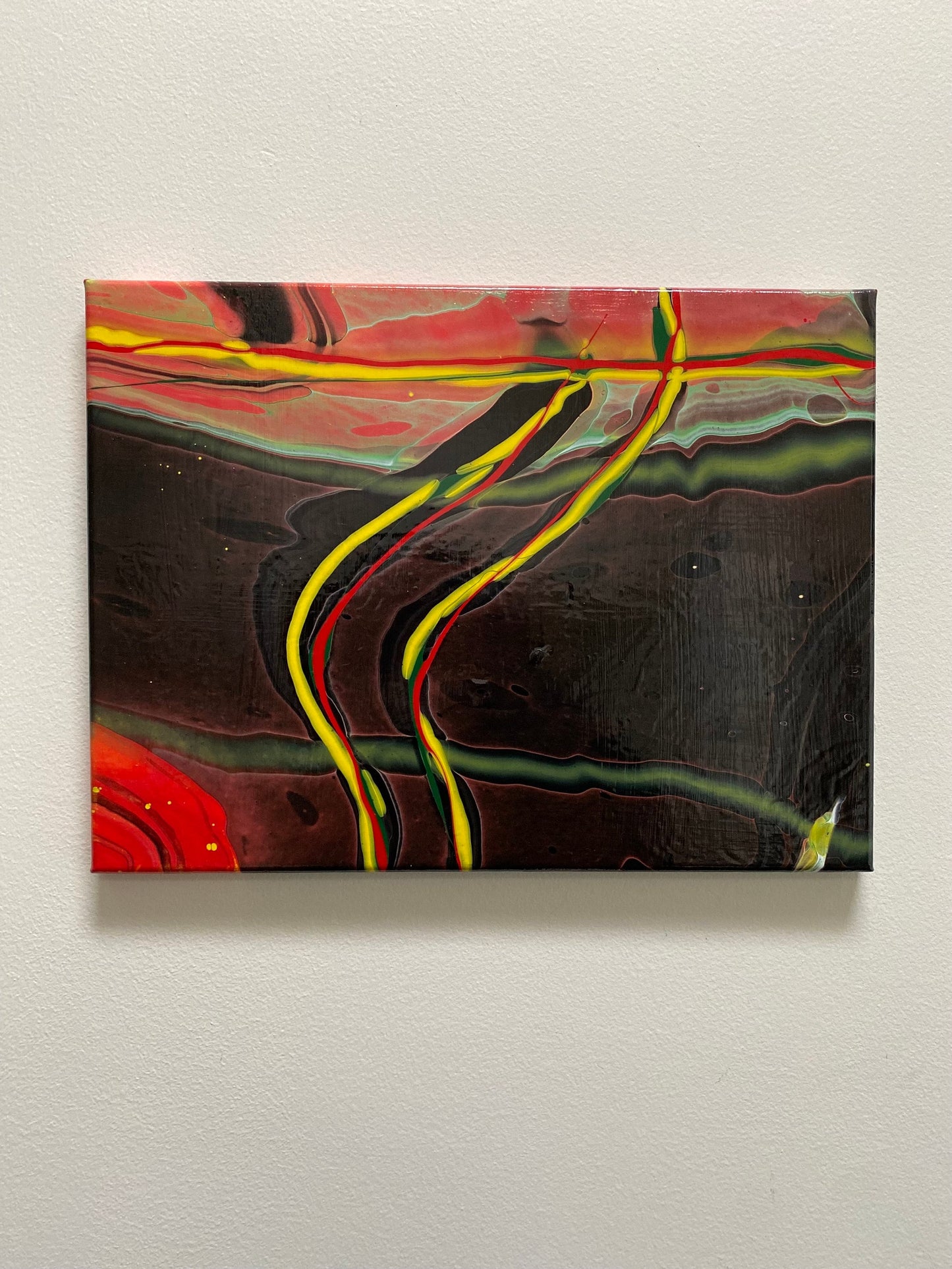 abstract fluid art featuring a black background, with yellow, red and green flowing lines